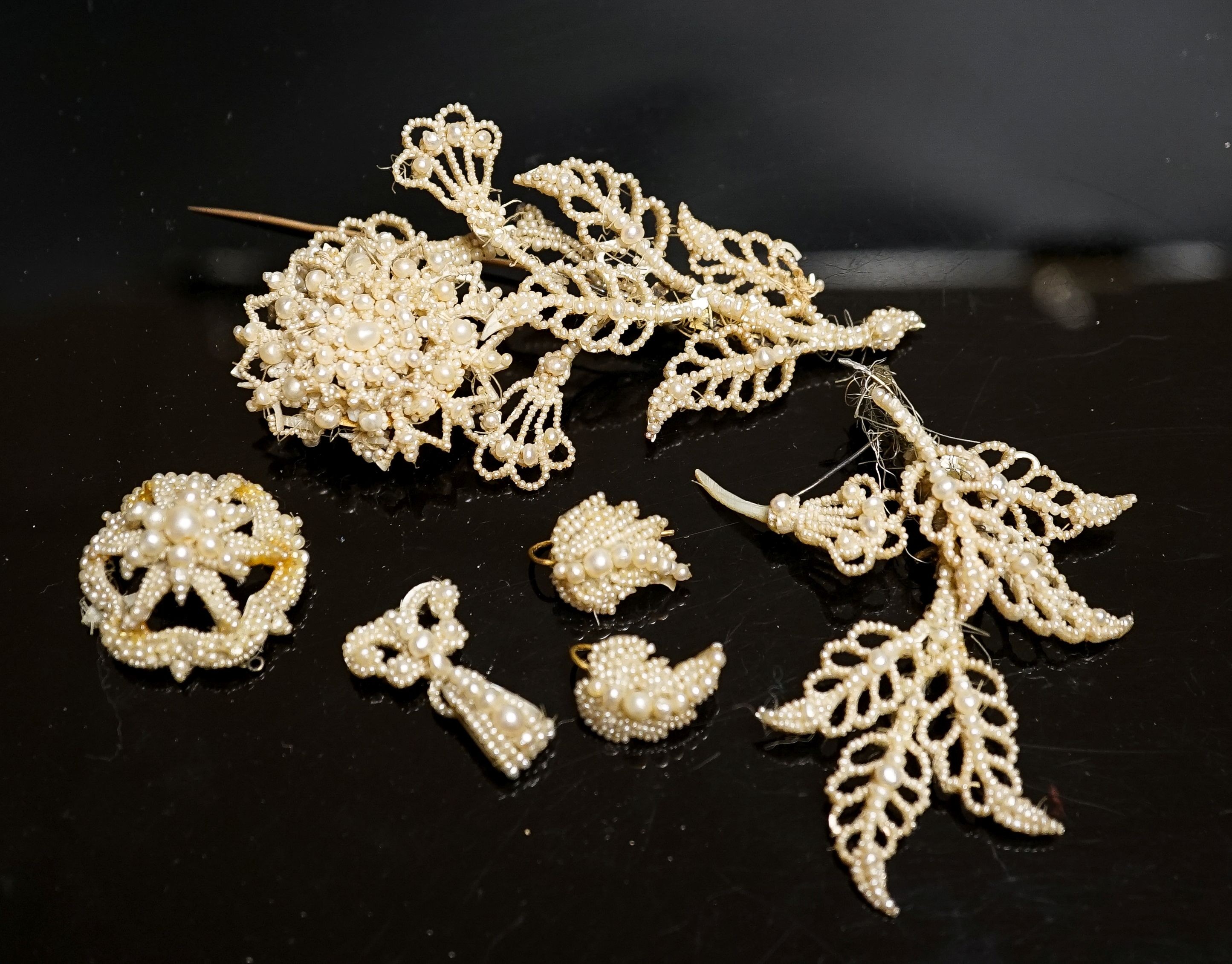 A 19th century seed pearl set flower brooch, 95mm and five other pieces of seed pearl jewellery.